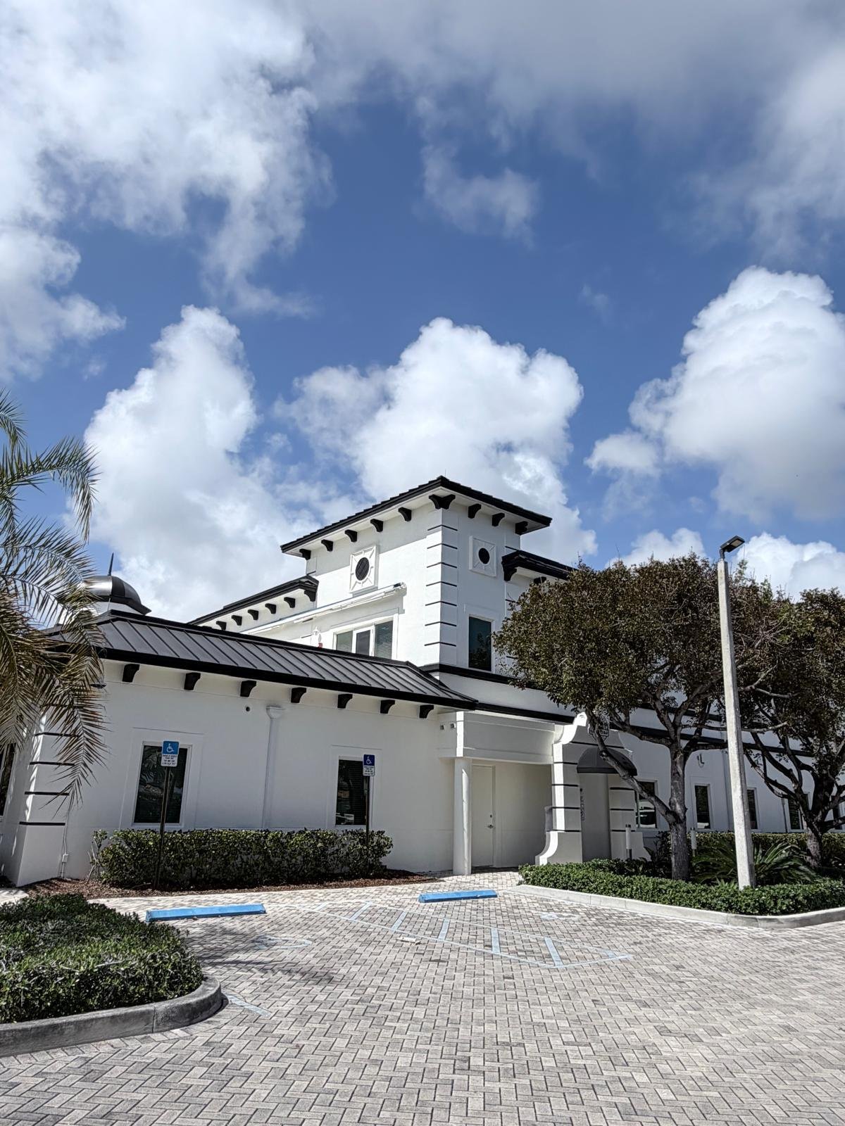 Completed commercial exterior painting project on a white building.